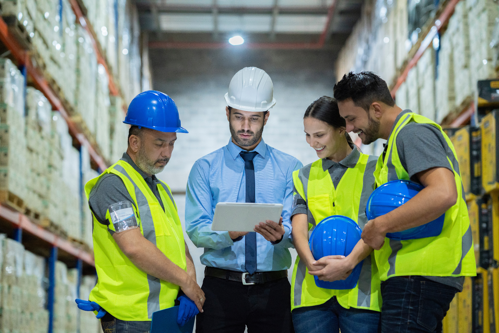 Person holding a tablet displaying a yearly calendar while drinking coffee, symbolizing year-end procurement planning and process streamlining.