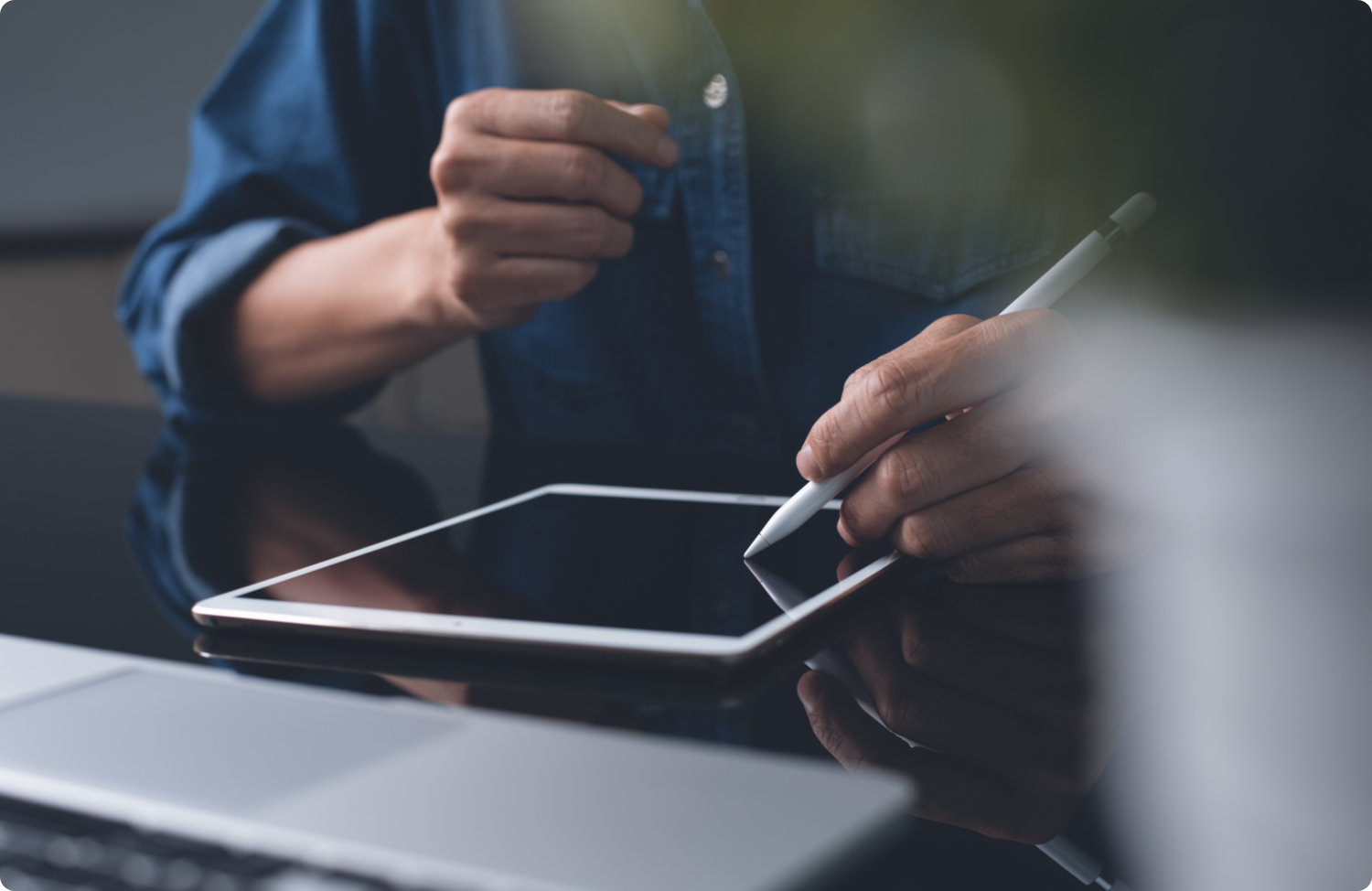 A procurement professional using a digital tablet with a stylus to review or approve bid documents, illustrating modern eProcurement workflows and digital evaluation processes.