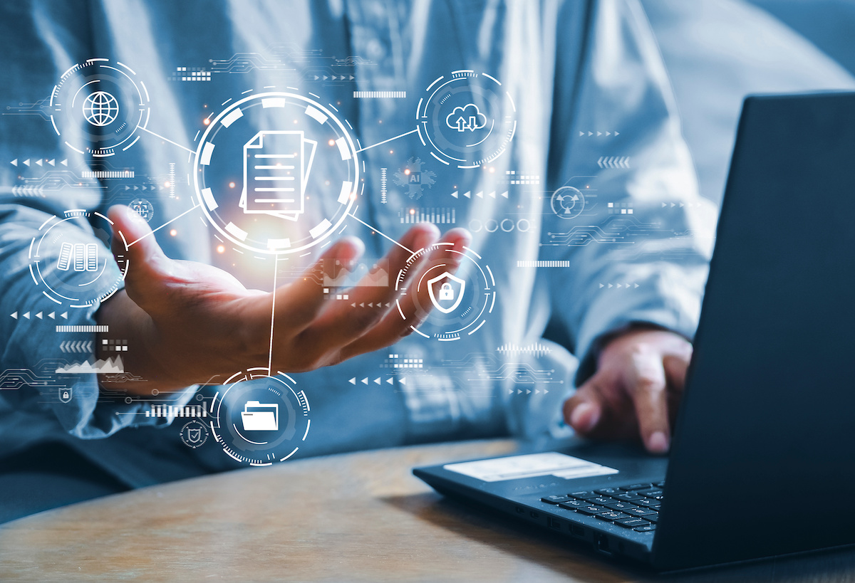 Person using a laptop with digital file and security icons floating above their hands, representing data retention and compliant procurement record management.
