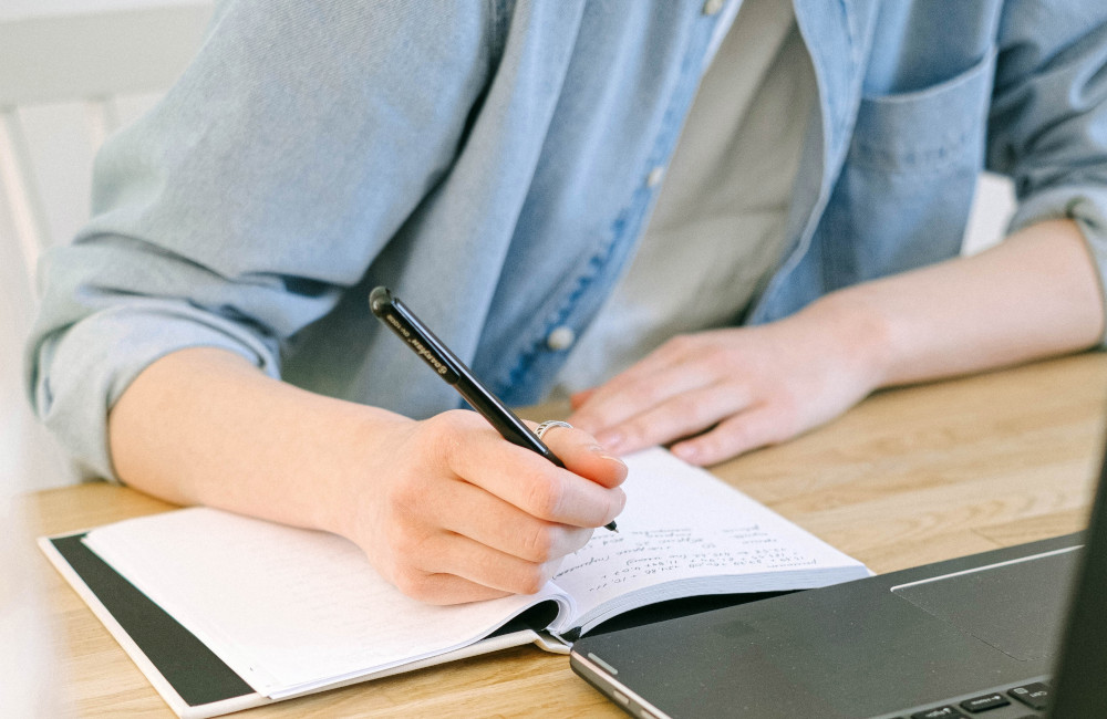 A procurement professional using a digital tablet with a stylus to review or approve bid documents, illustrating modern eProcurement workflows and digital evaluation processes.